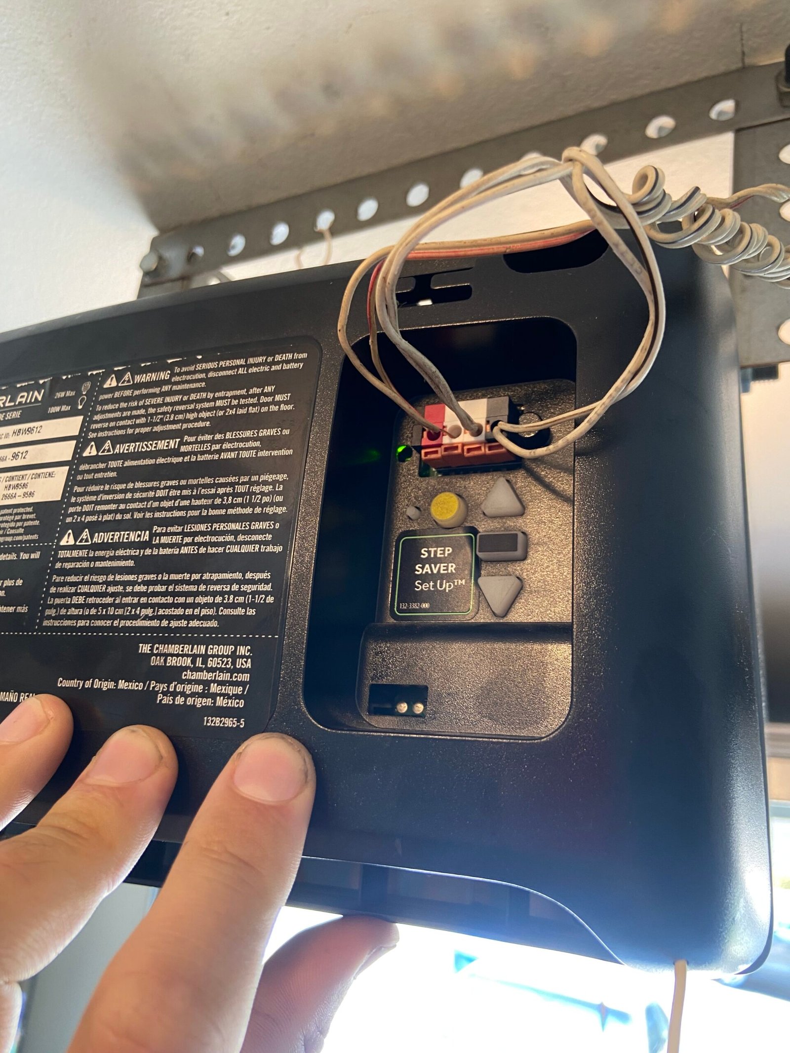 Technician servicing a Chamberlain garage door opener in Norwalk CA